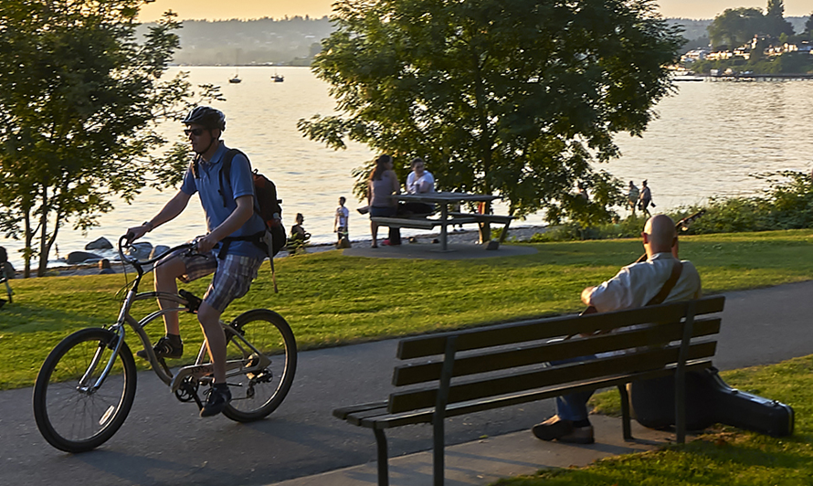 Man riding bicycle by lake